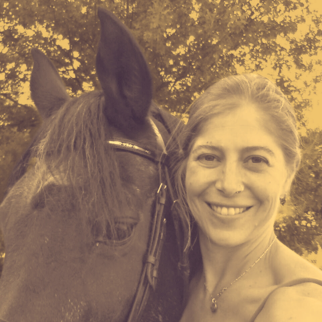 Sepia photograph: Ruth (Teji) Dilley stands cheek to cheek with a bridled dark horse under summer trees, smiling at the camera.